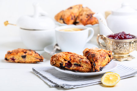 Homemade English buns with berries (scones) for traditional English tea, selective focus. Concept healthy homemade food.の写真素材