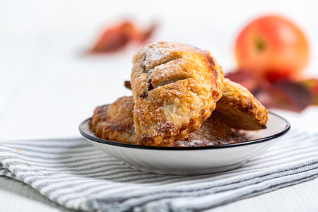 Homemade small apple pies on a plate. Concept of sweet homemade pastries.の写真素材