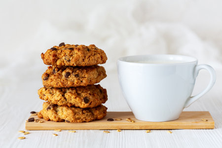 Fresh homemade oatmeal cookies with a cup of milk.