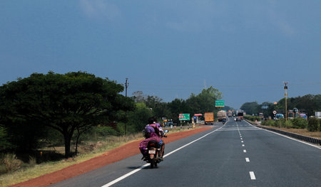 A couple riding bike on a highway in bikers lane