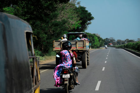 A duo traveling on a motorbike on a national highwayのeditorial素材