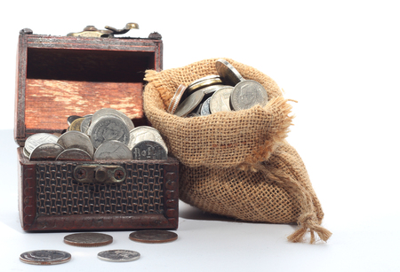Thai Baht coins in bags and wooden boxesの写真素材