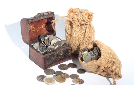 Thai Baht coins in bags and wooden boxesの写真素材
