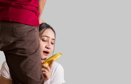 A woman with a yellow banana to make love valentine dayの写真素材