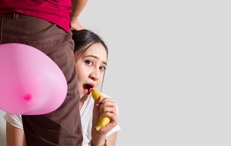 A woman with a yellow banana to make love valentine dayの写真素材
