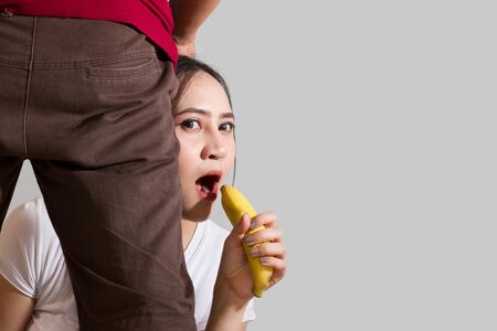 A woman with a yellow banana to make love valentine dayの写真素材
