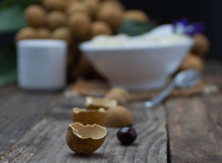 sweet sticky rice with Longan and coconut water., placed on an old wooden table