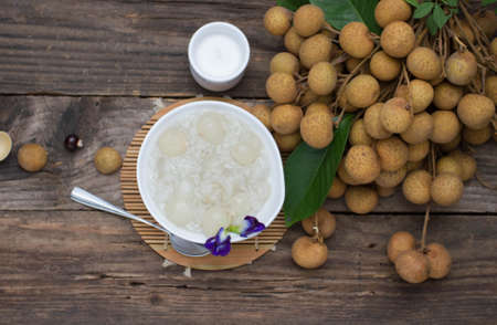 sweet sticky rice with Longan and coconut water., placed on an old wooden tableの写真素材