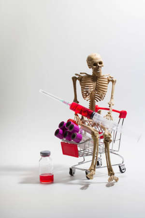 A skeleton with a shopping cart with a blood tubeの写真素材