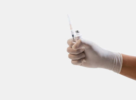 Close up of Nurse/Doctor hand holding a plastic Syringe, medical injection in hand. A syringe is a small tubeの写真素材