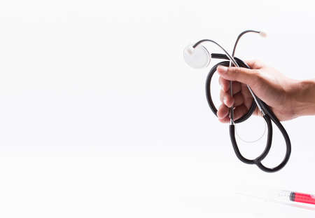 The doctor is holding the stethoscope to check the white background.