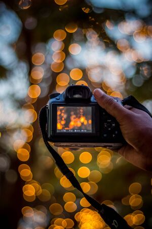 DSLR Camera on Bokeh Background - Black DSLR Camera With Bokeh Lights Photo and Camera City Lights Bokehの写真素材