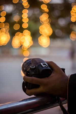 DSLR Camera on Bokeh Background - Black DSLR Camera With Bokeh Lights Photo and Camera City Lights Bokehの写真素材
