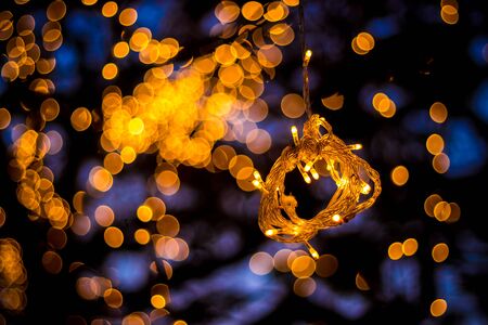 Bokeh Tree Light Decoration - Welcoming House and the fabulous party and Christmas night - Outdoor Trees have been decorated with yellow lightsの写真素材