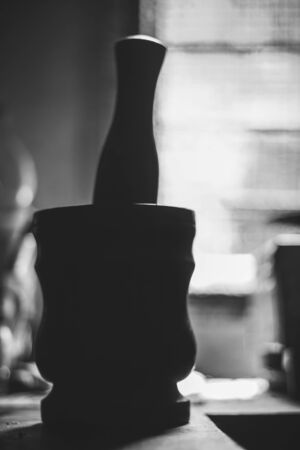 Wooden mortar with Pestle - Traditional Wooden garlic masher silhouettes on white and black background. Concept , okhli or ukhli mortar wood manual grinder for pounding spice.の写真素材