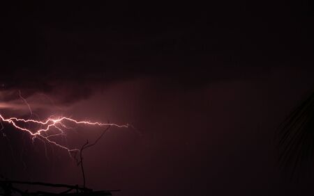 Lightning storm over the city buildings. Lightning bolt strike during a thunderstorm on metropolitan...