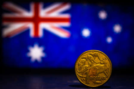 Australian dollar coin isolated on Australia flag background with space for copy text. One dollar coin 1995 Australian currency. Old coins collection world wide.の写真素材