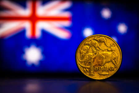 Australian dollar coin isolated on Australia flag background with space for copy text. One dollar coin 1995 Australian currency. Old coins collection world wide.の写真素材