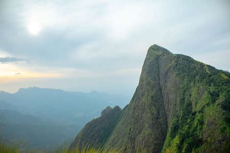 Kolukkumalai Sunrise view point. Early morning in the mountain at sunrise with flowing clouds. world 2nd highest tea plantation. Kolukkumalai tea estate point shooting. Kerala, Tamil Nadu, India.の写真素材