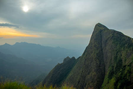 Kolukkumalai Sunrise view point. Early morning in the mountain at sunrise with flowing clouds. world 2nd highest tea plantation. Kolukkumalai tea estate point shooting. Kerala, Tamil Nadu, India.の写真素材