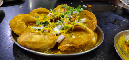 Spicy Pani puri with Chickpea masala stuffed on plate. Famous Indian Snacks Stock Images.の写真素材