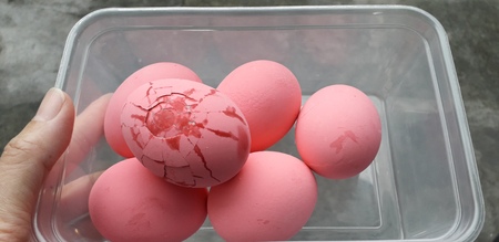 Pink eggs have cracks  strange shape. On a white background ,Century egg.