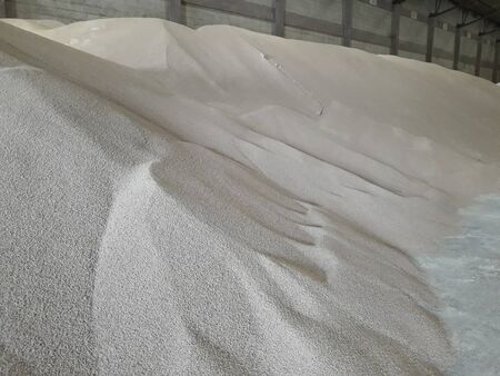 Chemical fertilizer piles in the warehouse are waiting for the delivery of the type of bulk.の写真素材