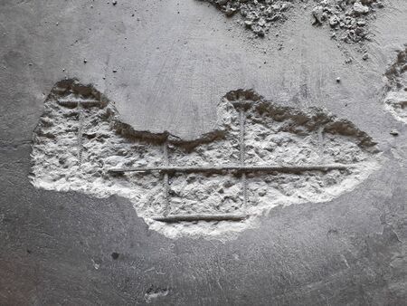 The damaged wall is visible to the internal steel bar.  The plaster should be  repaired With mortar...