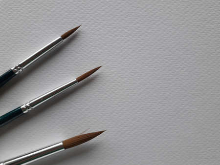 White drawing paper And a black-green handle paintbrush for drawing