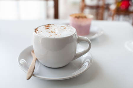 a cup of coffee on a white deskの写真素材