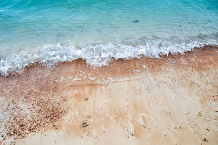 Wave of the sea on the sand beachの写真素材