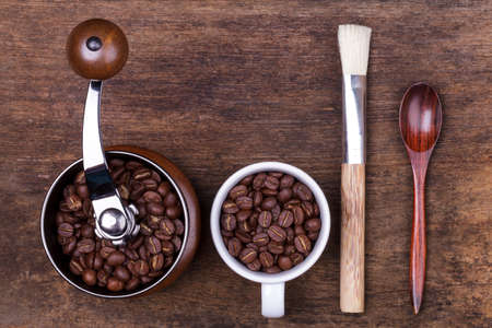 cup of coffee beans on the brown wooden backgroundの写真素材