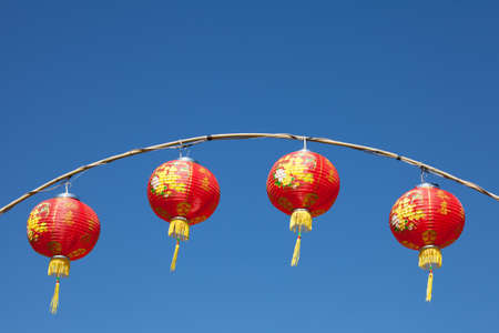 Red chinese lanterns with blue skyの写真素材