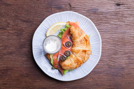 Croissant with salmon and capersの写真素材