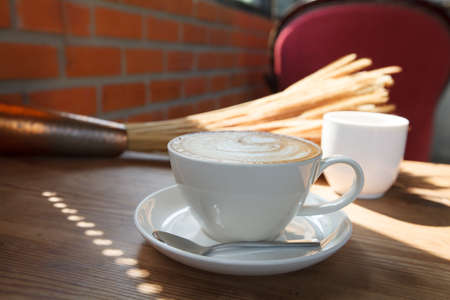 A cup of coffee latte on wood tableの写真素材