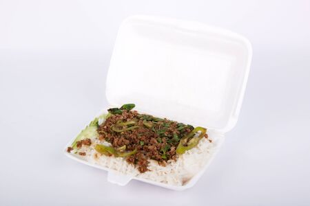thai spicy food basil pork fried rice recipe in foam boxの写真素材