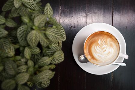 Cup of latte coffee on wooden tableの写真素材