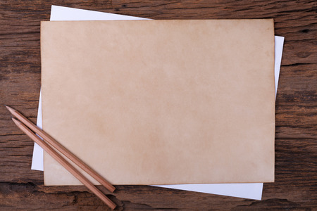 Old paper with  pencil on wooden tableの写真素材