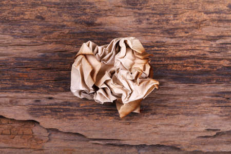 crumpled paper ball on woodの写真素材