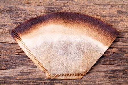 Coffee filter with brewed coffee on wood backgroundの写真素材