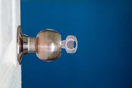 Open door with keys, key in keyholeの写真素材