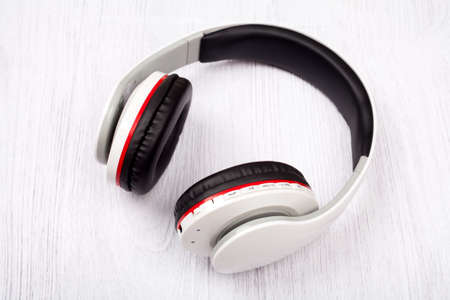  headphones on white wood background