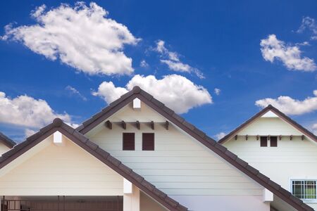 Detail of house exterior wall and blue sky with cloud