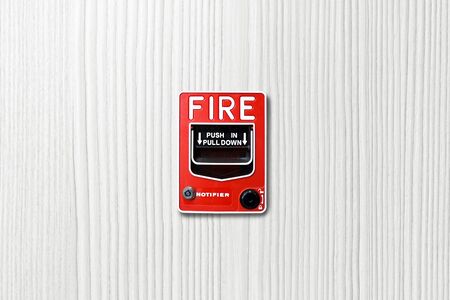 Fire alarm switch on white wood backgroundの写真素材
