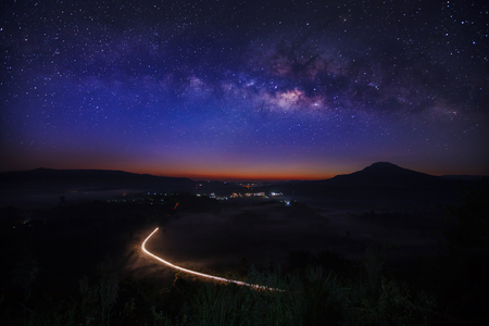 Milky way galaxy with lighting on the road at Khao Takhian Ngo View Point at Khao-kho Phetchabun,Thailand, Long exposure photographの写真素材