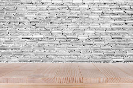 brown wood table top on white concrete wall background - can be used for montage or display your productsの写真素材
