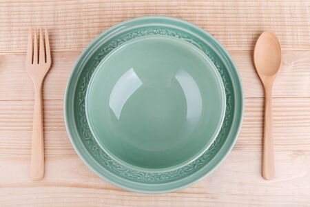 Empty caramic celadon dish and spoon forkの写真素材