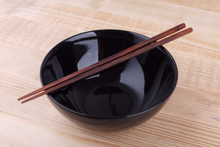 Chopsticks in asian set table on wood backgroundの写真素材