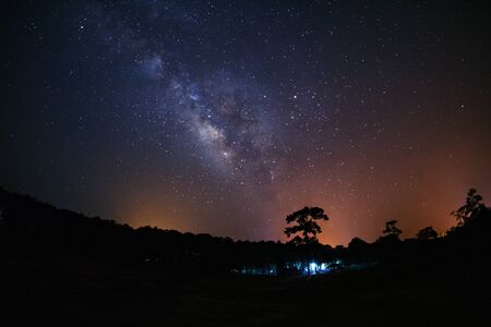 milky way and silhouette of Tree with cloud. Long exposure photograph.with grainの写真素材