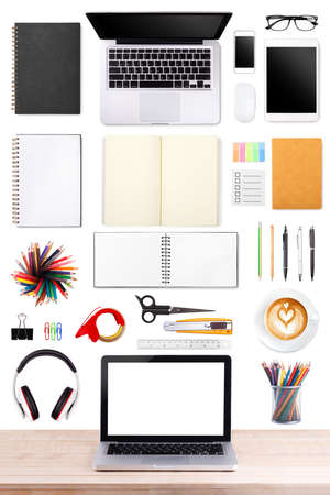 Businessman's desk with laptop, tablet smartphone and office supplies on white backgroundの写真素材